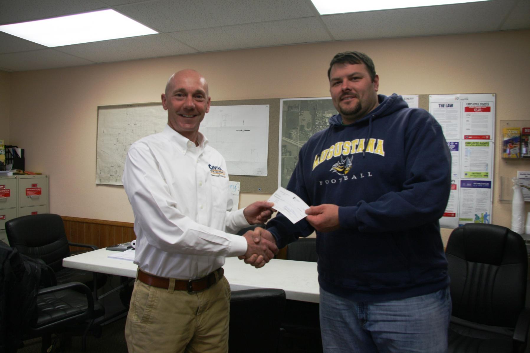 Central Electric Manager of Finance and Administration Scott Kroger (left) presents check to Mayor Joshua Kayser (right)
