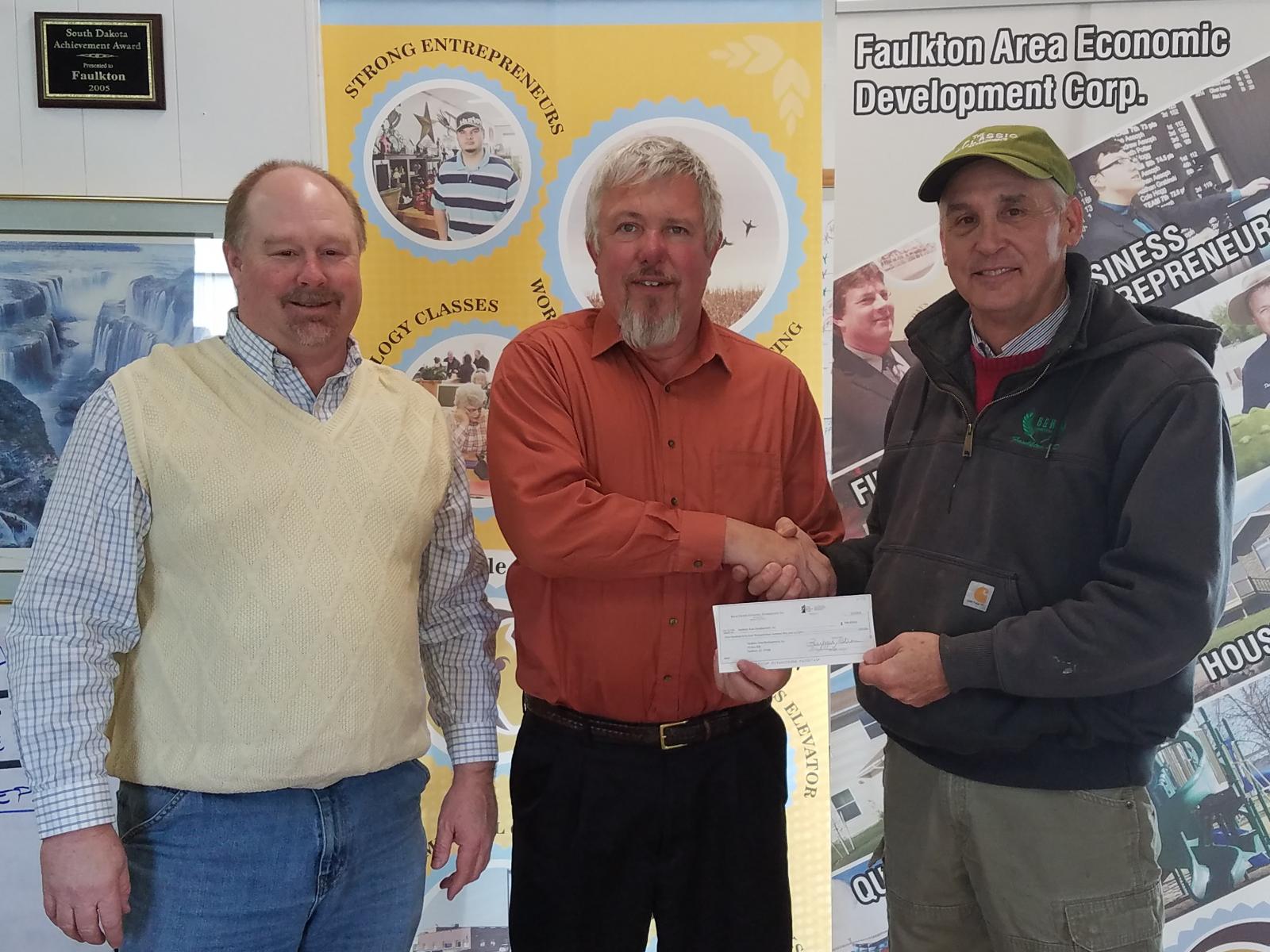 FEM General Manager Scott Moore presents a check to representatives from the Faulkton Area Economic Development Corporation at the loan closing
