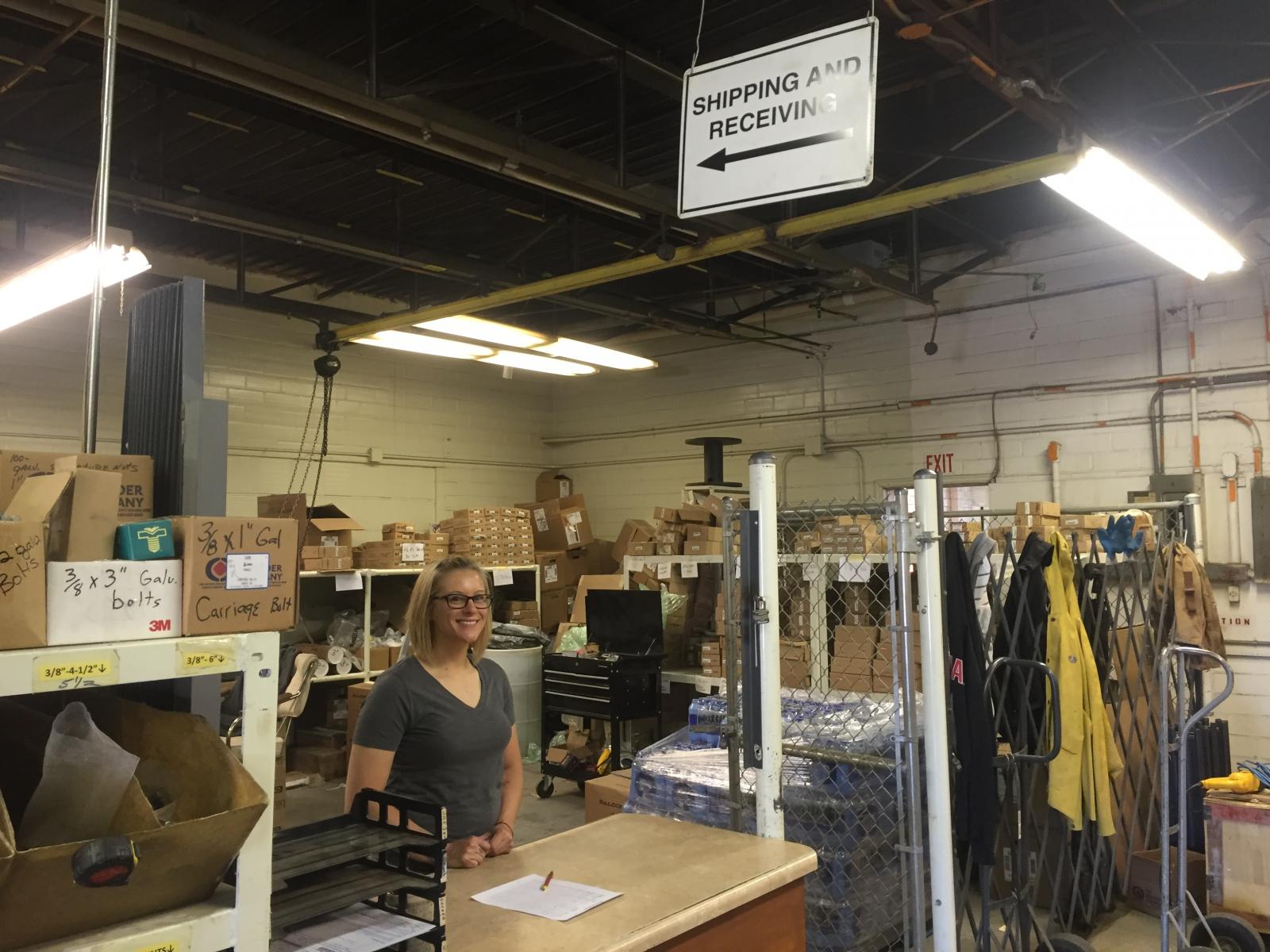 Brittany White stands behind the shipping and receiving desk at Ranco in Sioux Rapids. White, an army veteran, utilized Home Base Iowa to find employment in the region.