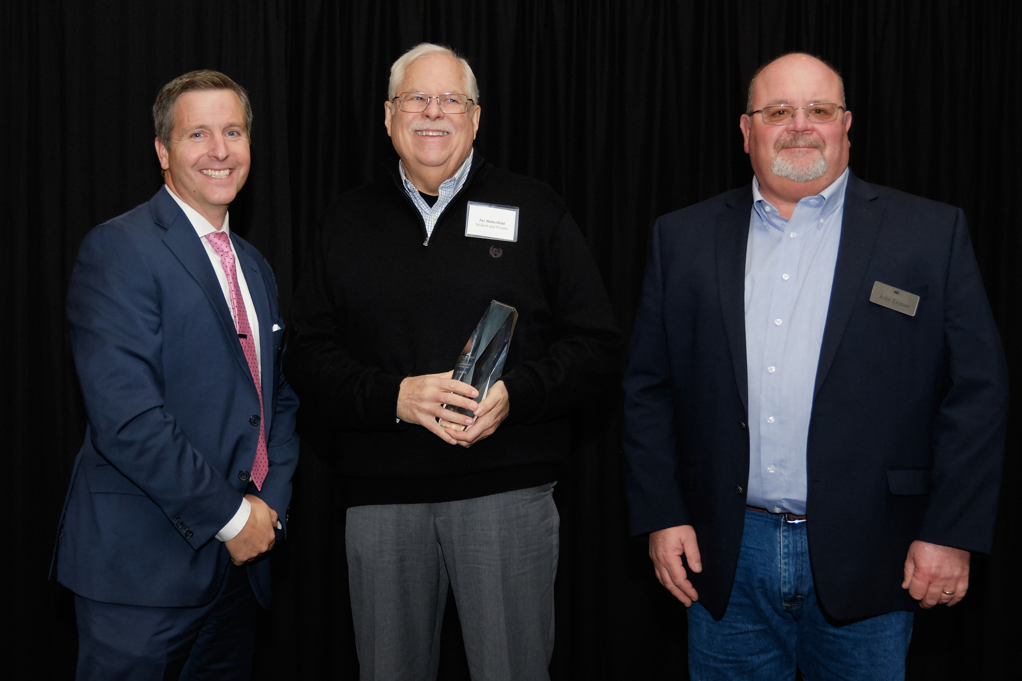 L to R: Corridor CEO Kiley Miller, 2019 Entrepreneur of the Year Jay Butterfield (Stickers and Posters), Corridor Board Chair John Tatman