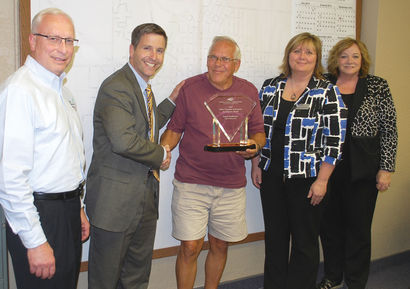 Larry Anderson, centered, receiving the Public Champion for Economic Development Award. From left: Rick Olesen, ILCDC Board of Directors; Kiley Miller, ILCDC CEO; Larry Anderson; Penny Clayton, ILCDC Board of Directors; Val Newhouse, ILCDC Board of Direct