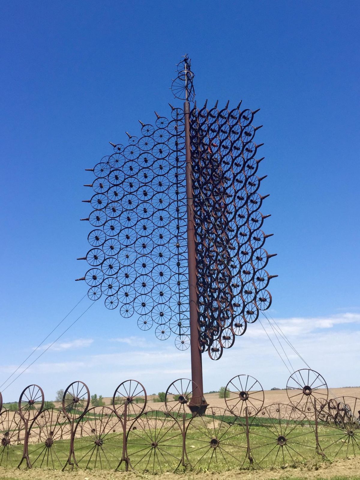 d.	LJ Maasdam Wagon Wheel Sculpture's Logo