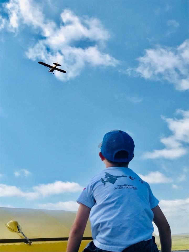 boy looking at plane