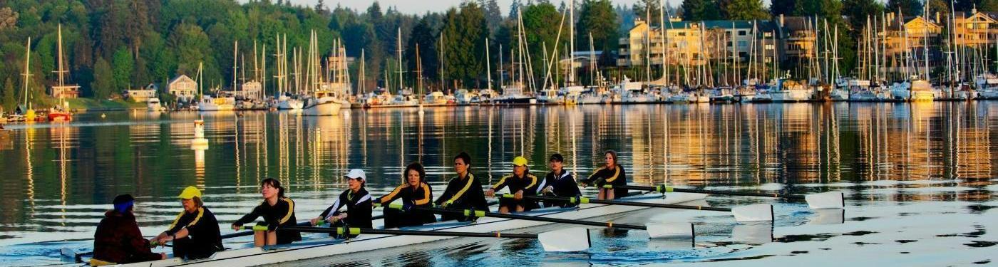 rowing team crew rowing towards the harbor