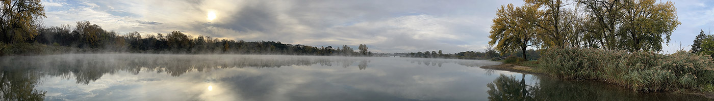 sunrise and fog lifting on a small lake