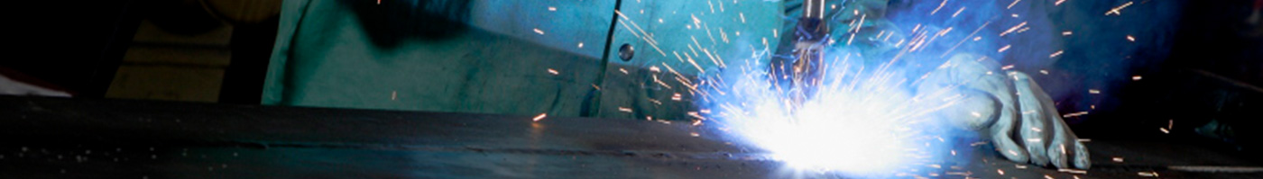 person welding, sparks flying