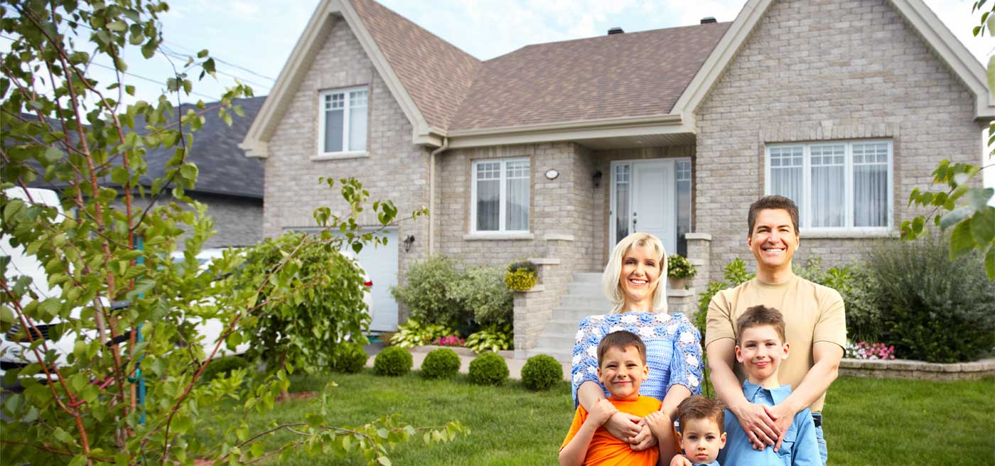 Happy family in front of a nice home