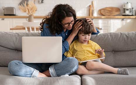 Mother with laptop and her child