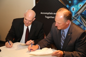 Greater Omaha Chamber President David Brown and GFDC President Scott Meister sign the partnership agreement.- May 22, 2013