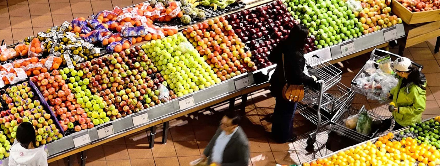 overhead view of shoppers in the produce aisle